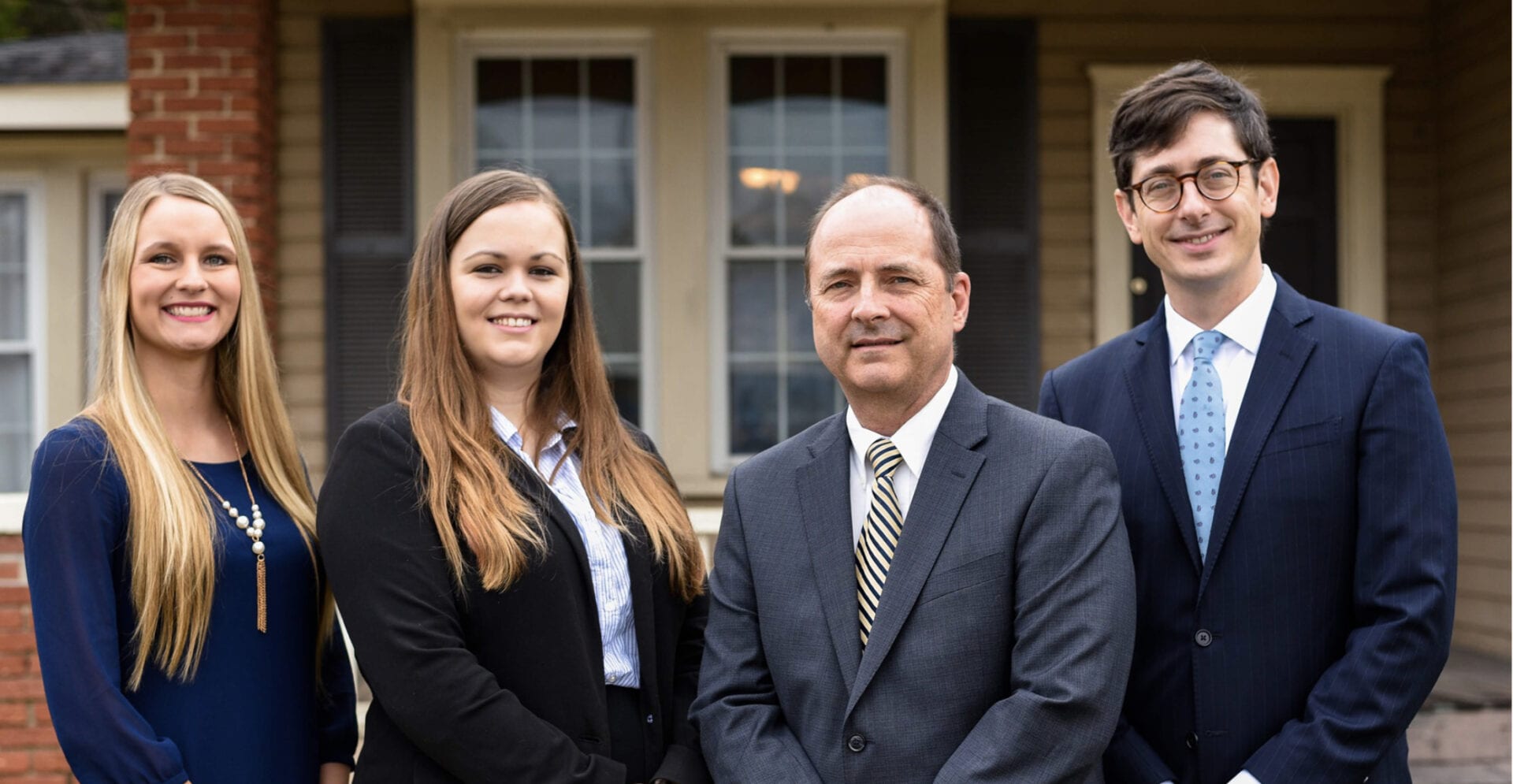 Four people standing together